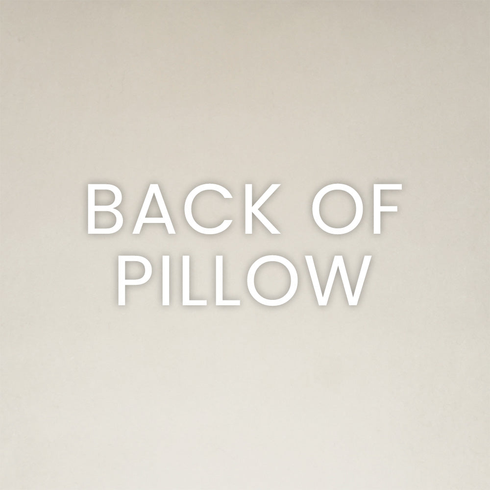 Back view of a beige pillow with soft fabric and subtle texture; neutral minimalist decor.