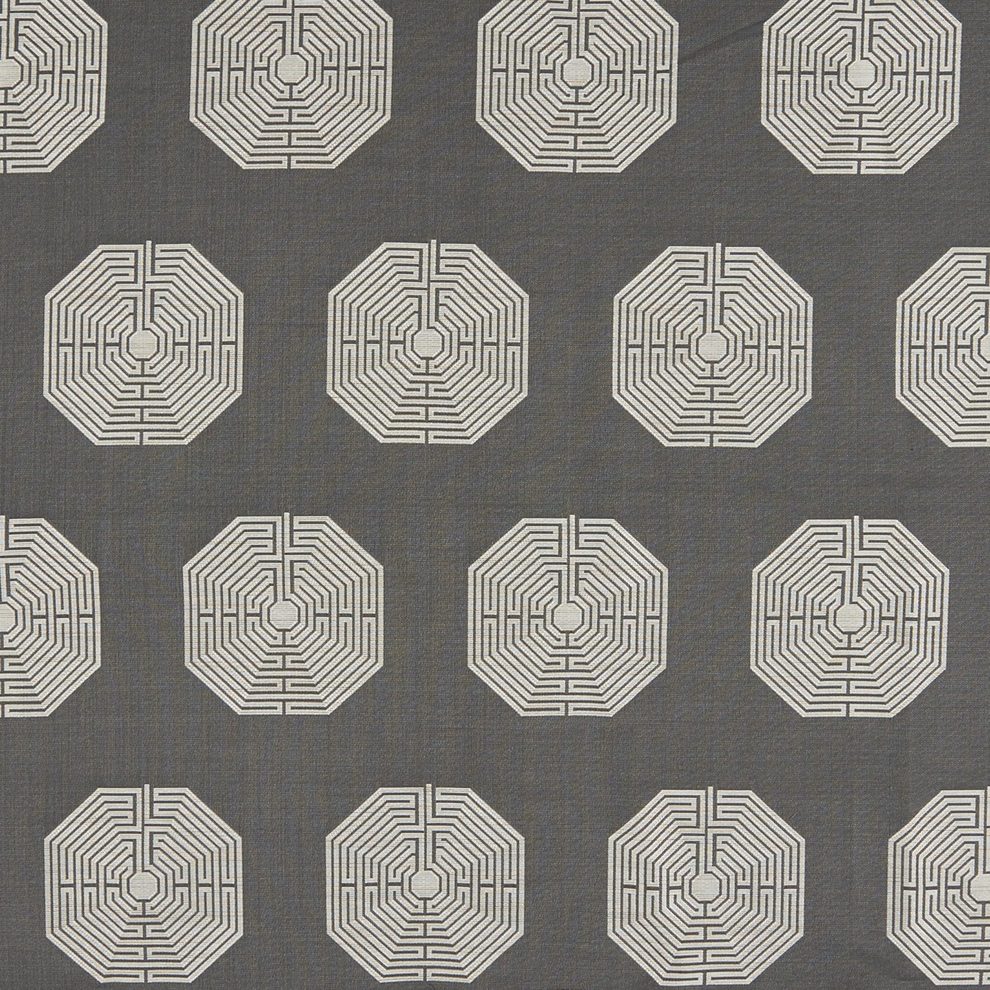 Charcoal gray fabric with repeating ivory octagon maze patterns; modern geometric textile for upholstery or drapery.