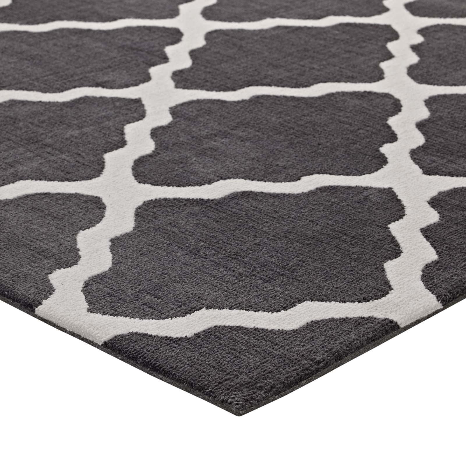 Dark charcoal rug with ivory trellis pattern and soft plush pile.