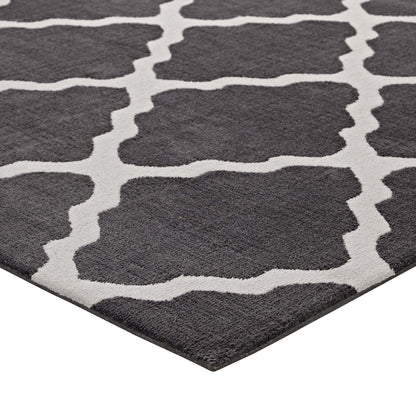 Dark charcoal rug with ivory trellis pattern and soft plush pile.