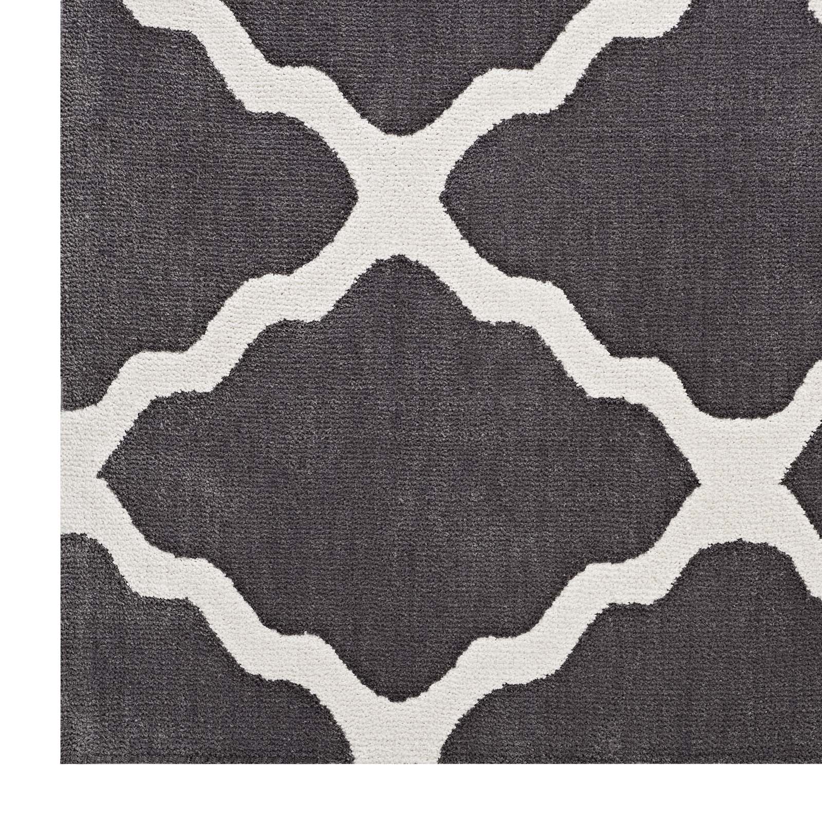 Dark gray rug with cream interlocking lattice pattern and woven texture; modern geometric trellis design.