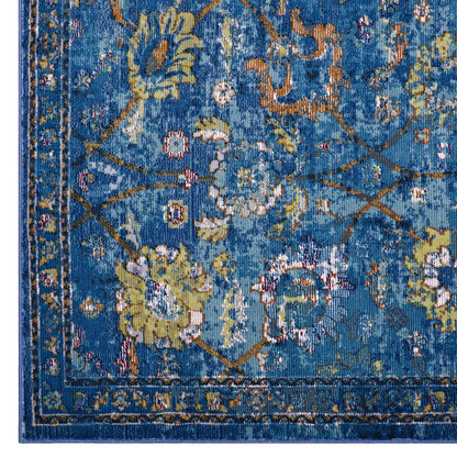 Blue Persian-style woven rug with yellow ivory floral motifs and ornate border.