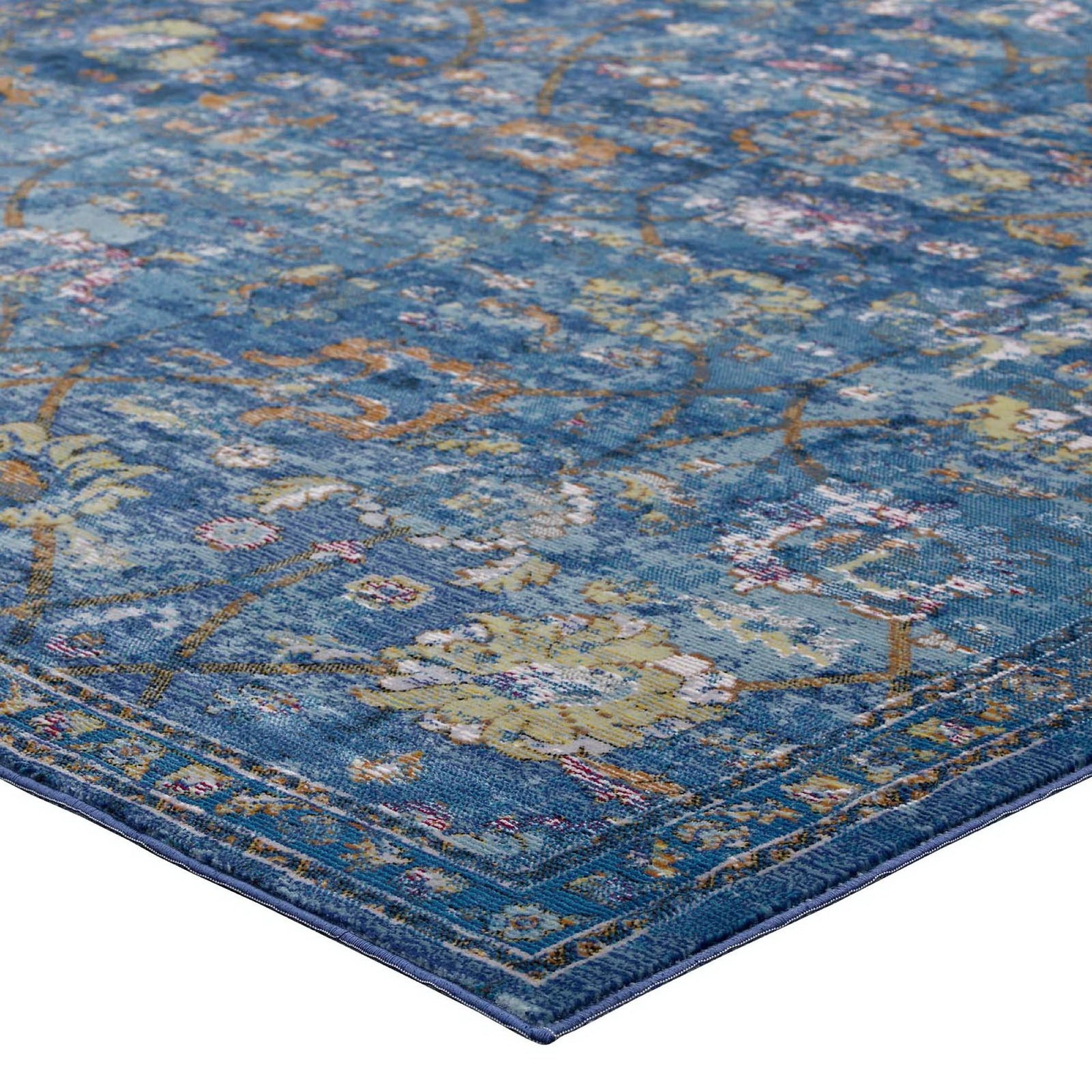 Blue oriental floral rug with yellow and orange accents; woven textile, rectangular shape, dark blue border.