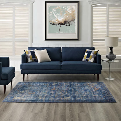 Dark blue 4x6 area rug with a distressed floral lattice pattern in yellow and orange.
