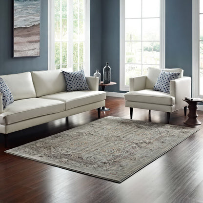 Rectangular area rug with a brown and silver-blue distressed vintage floral lattice pattern.