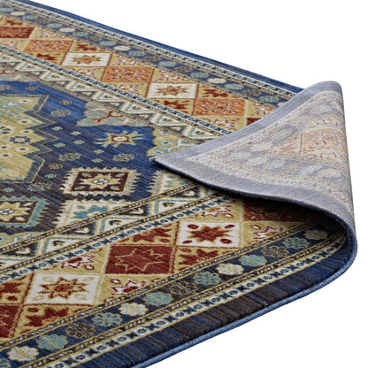 Colorful Southwestern diamond floral rug with blue, red, and tan tones; woven textile with a folded corner showing the underside.