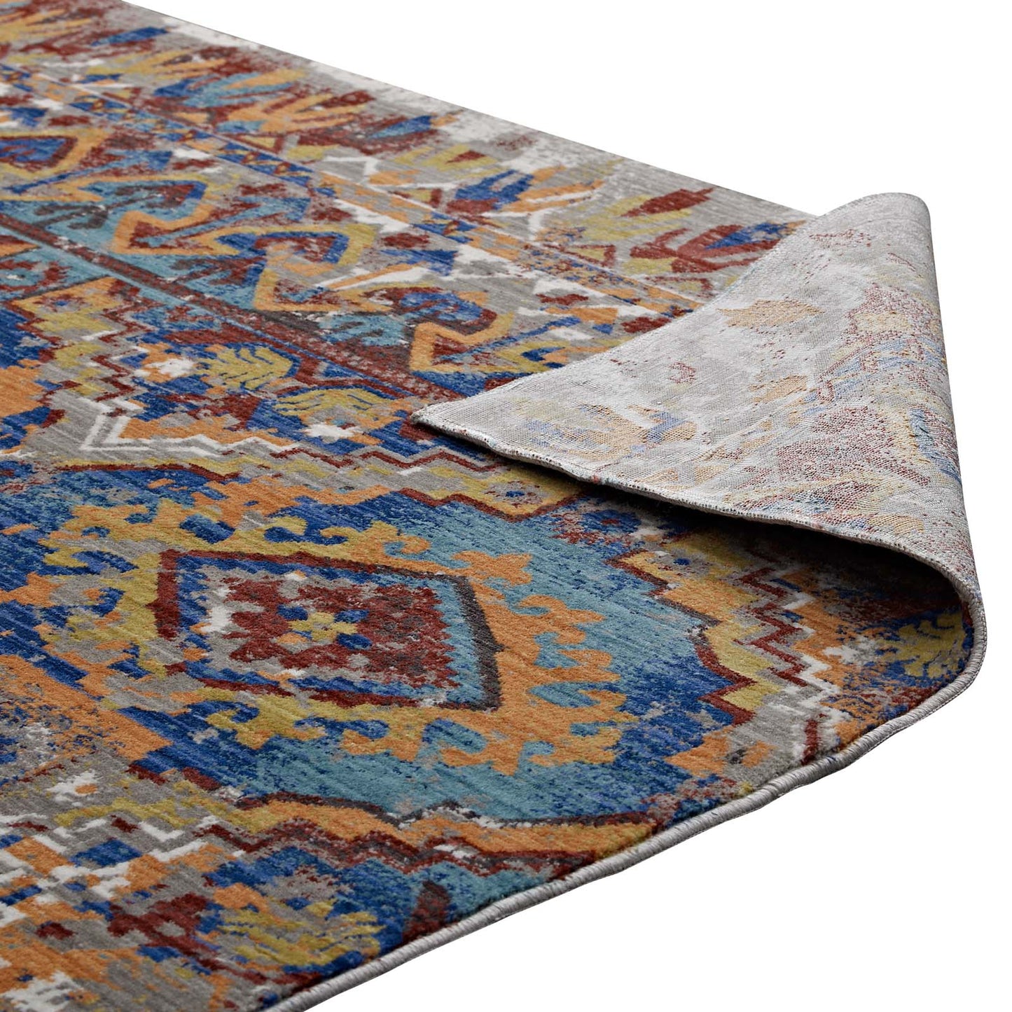 Colorful Southwestern Aztec-inspired area rug in blues, oranges and yellows; rolled corner reveals light gray backing; 8x10 ft.