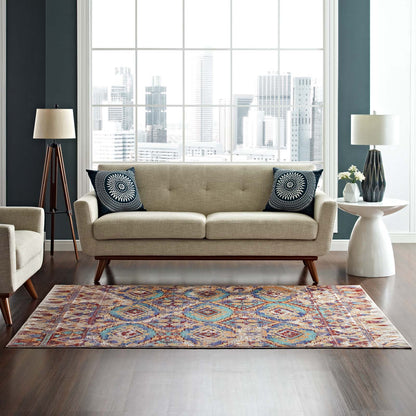 Distressed Southwestern Aztec multicolored 8x10 area rug on the floor in a living room setting.