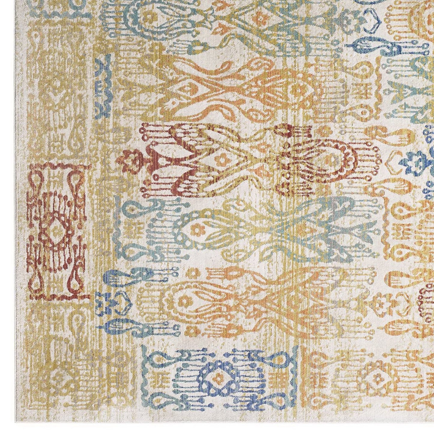 Rectangular patchwork rug with distressed Southwestern Aztec motifs in blue, gold, orange, red, and green on cream.