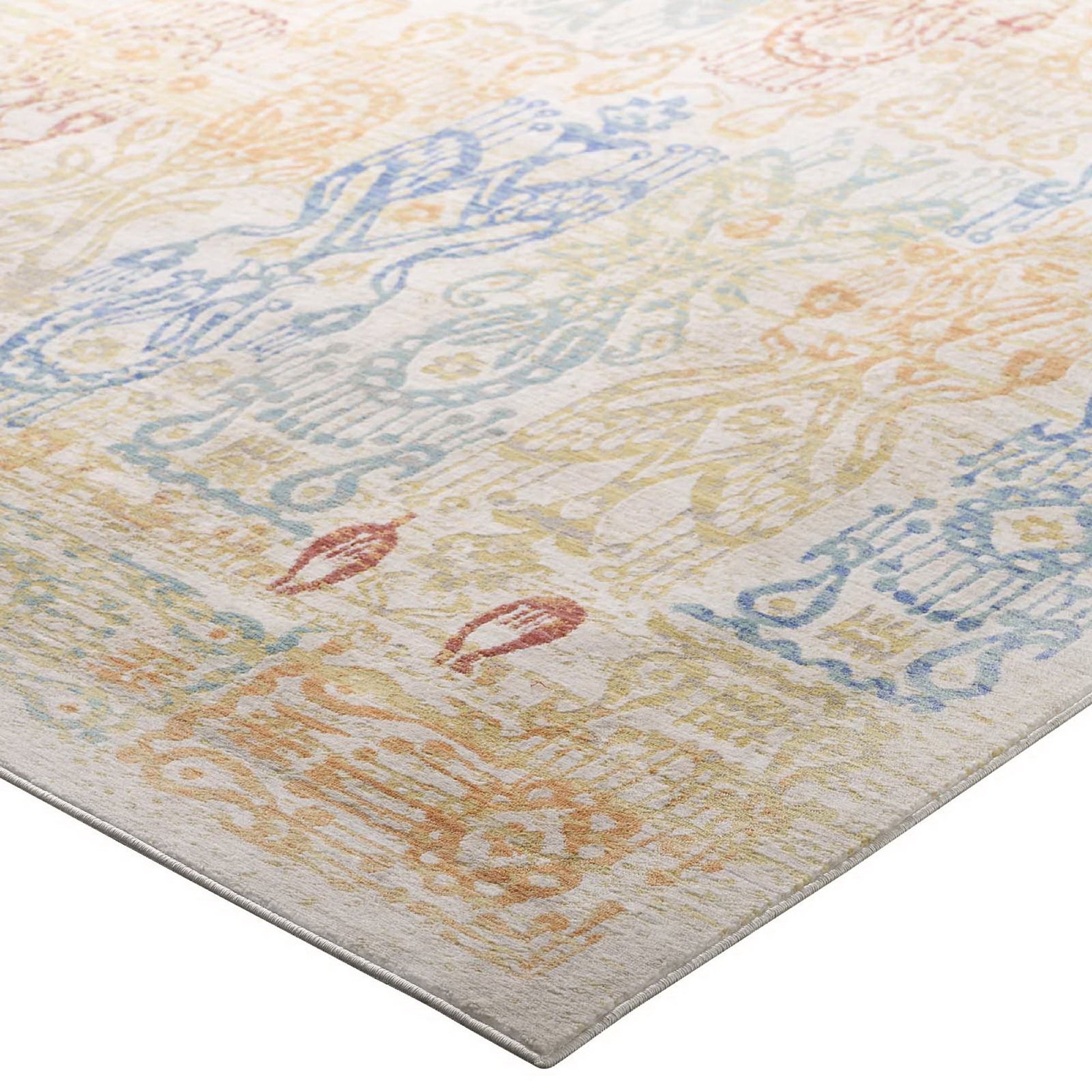 Rectangular distressed Southwestern Aztec 4x6 area rug, multicolored with faded geometric motifs in blue, peach and yellow on an ivory ground.