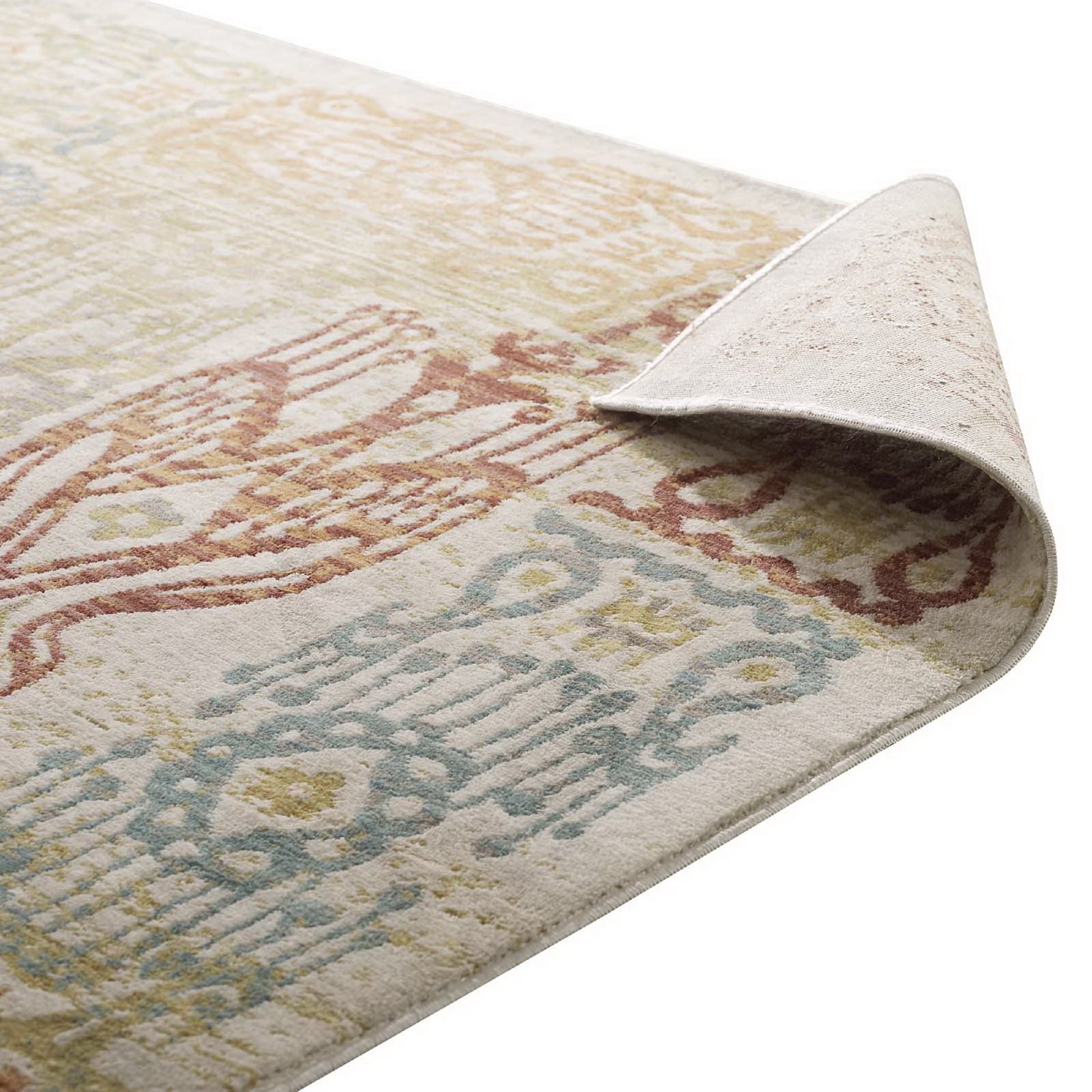 Pastel vintage-style area rug with pink, blue and yellow medallion motifs on beige; soft woven look, corner lifted.