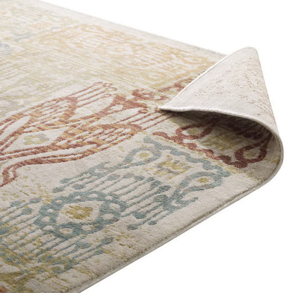 Pastel vintage-style area rug with pink, blue and yellow medallion motifs on beige; soft woven look, corner lifted.