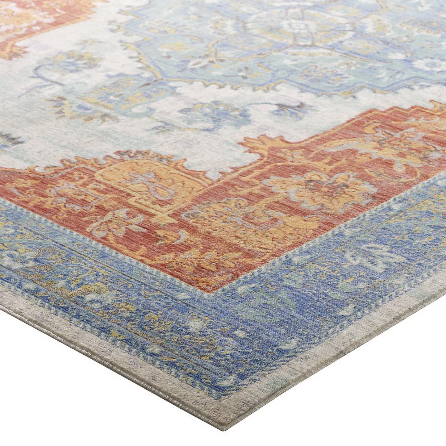 Southwestern Aztec patterned area rug with multicolored geometric motifs.