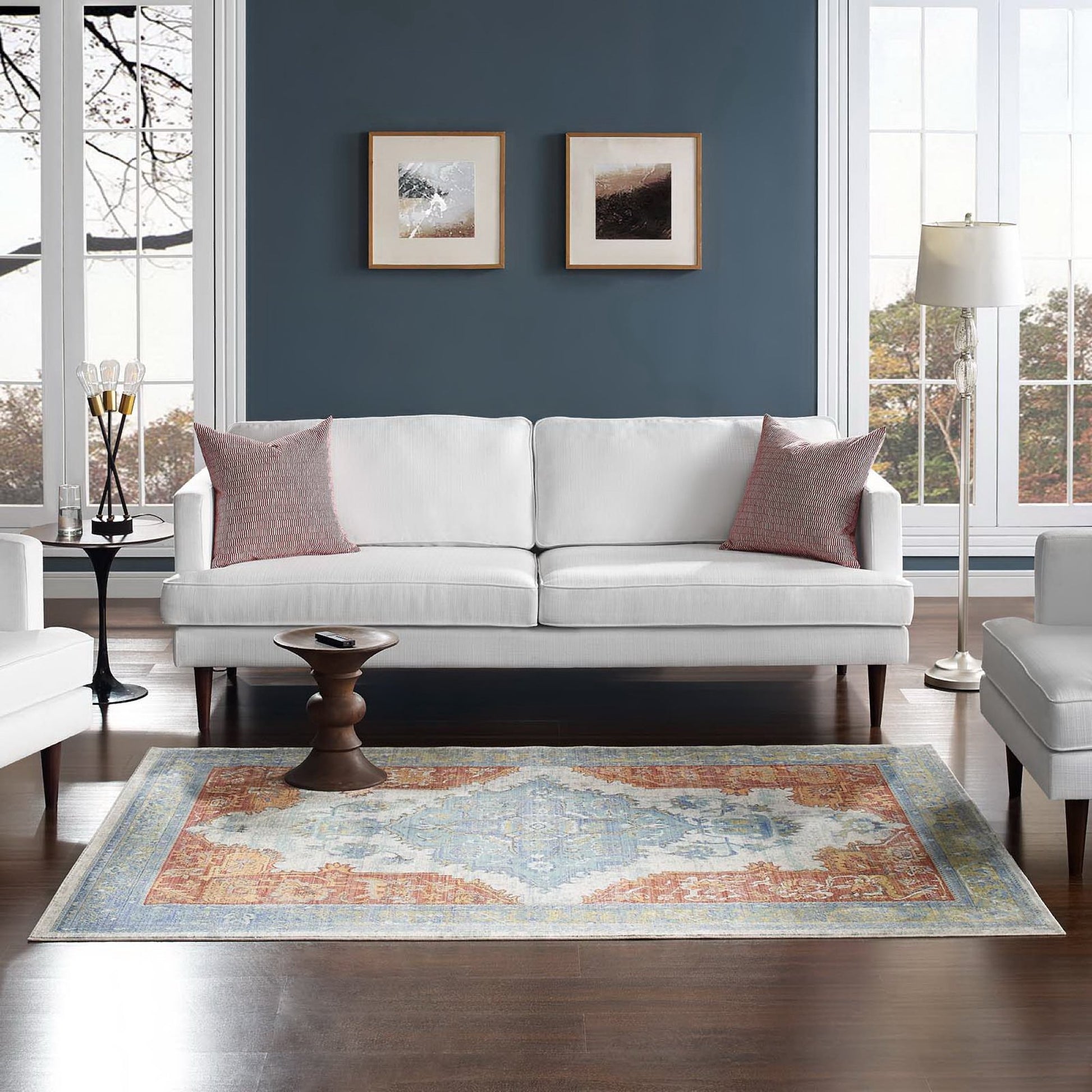 Multicolored distressed Southwestern Aztec area rug (4x6) on a living room floor; features cream, blue and pink tones.