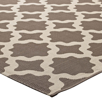 Taupe and beige flat-weave area rug with repeating rounded-square geometric motifs.