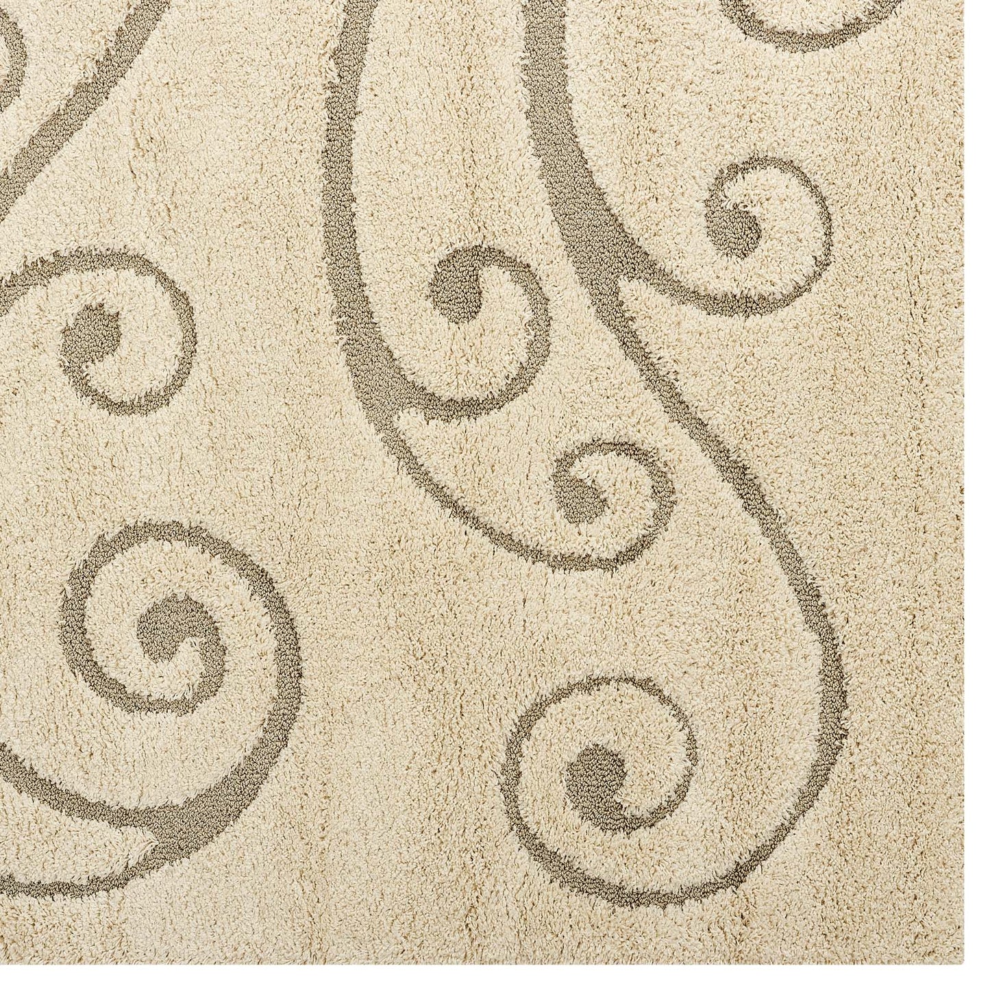Cream and beige area rug with a scrolling vine motif; plush shag texture for living room decor.