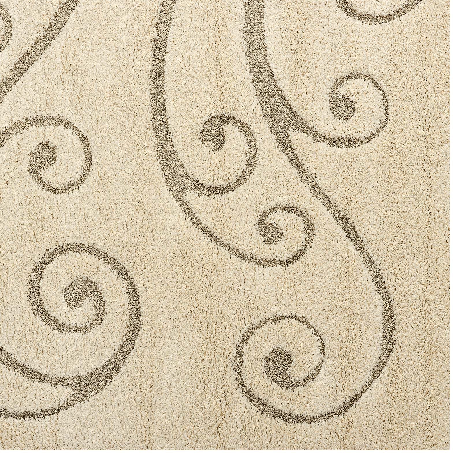 Cream and beige area rug with a scrolling vine motif; plush shag texture for living room decor.