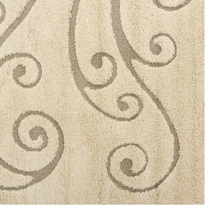 Cream and beige area rug with a scrolling vine motif; plush shag texture for living room decor.