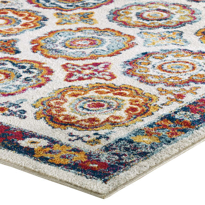 Colorful oriental-inspired area rug with distressed floral Moroccan trellis pattern in orange, teal, yellow and red on ivory, fringed border.