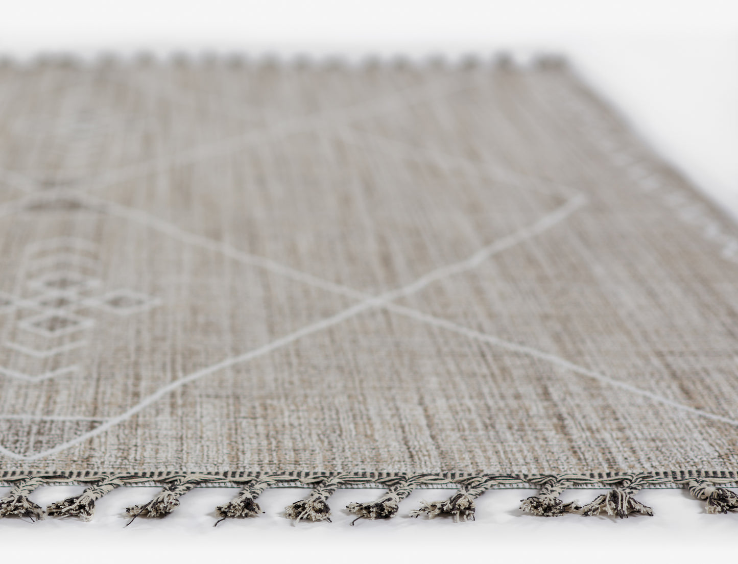Gray textured woven rug with white cross lines and tassel fringe along the edge (5' x 8').