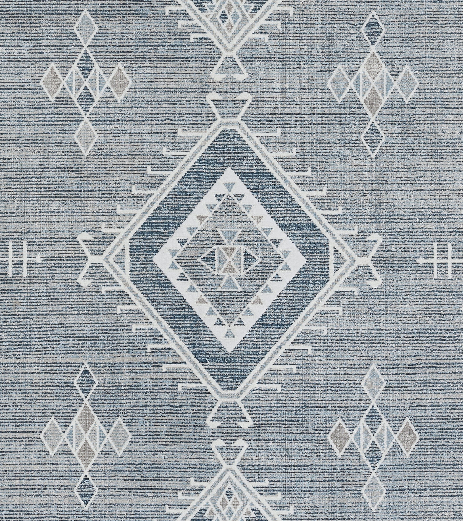 Blue woven rug with white geometric diamonds, including a central nested diamond motif.