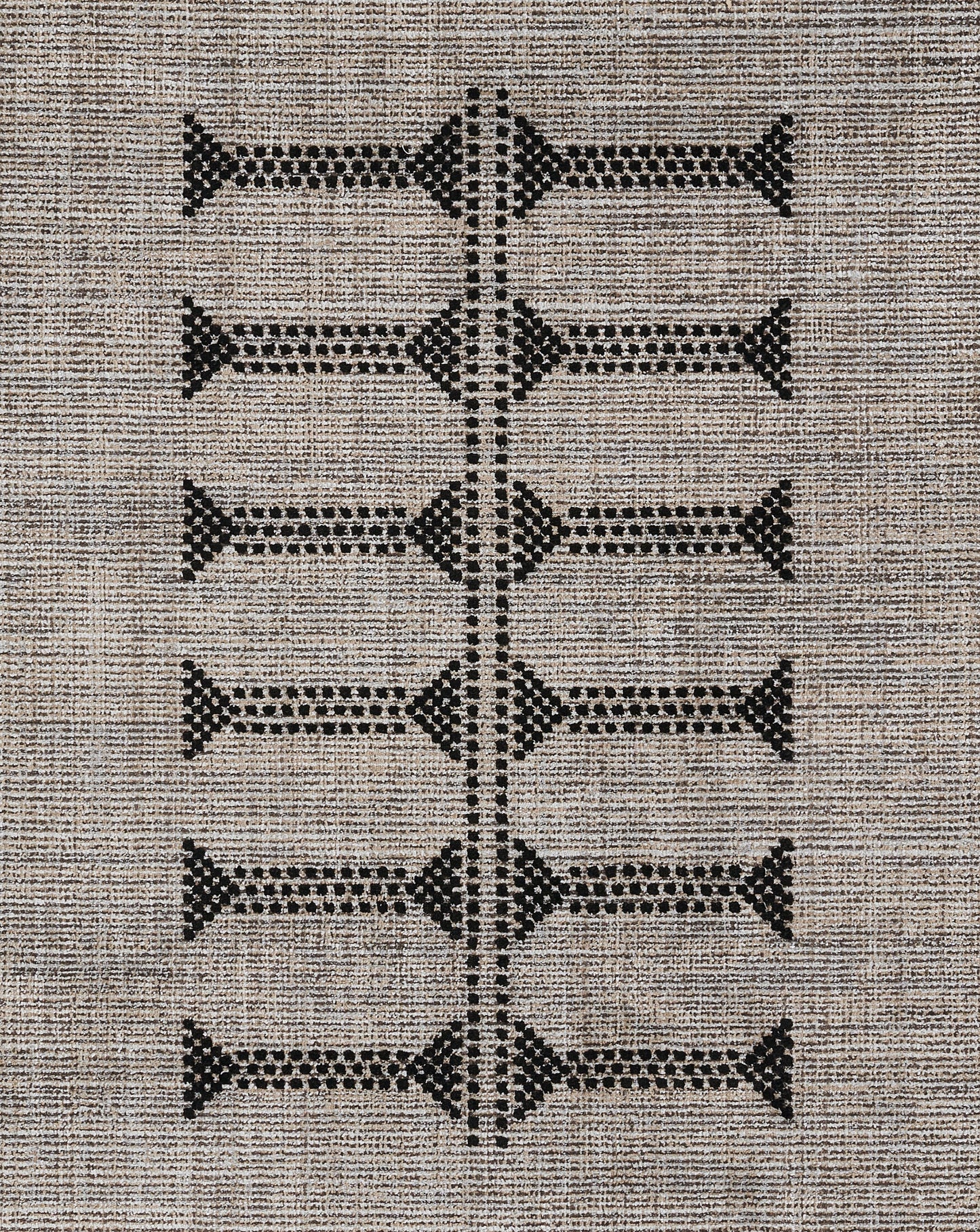 Beige woven area rug with black geometric diamonds arranged in a vertical ladder motif.