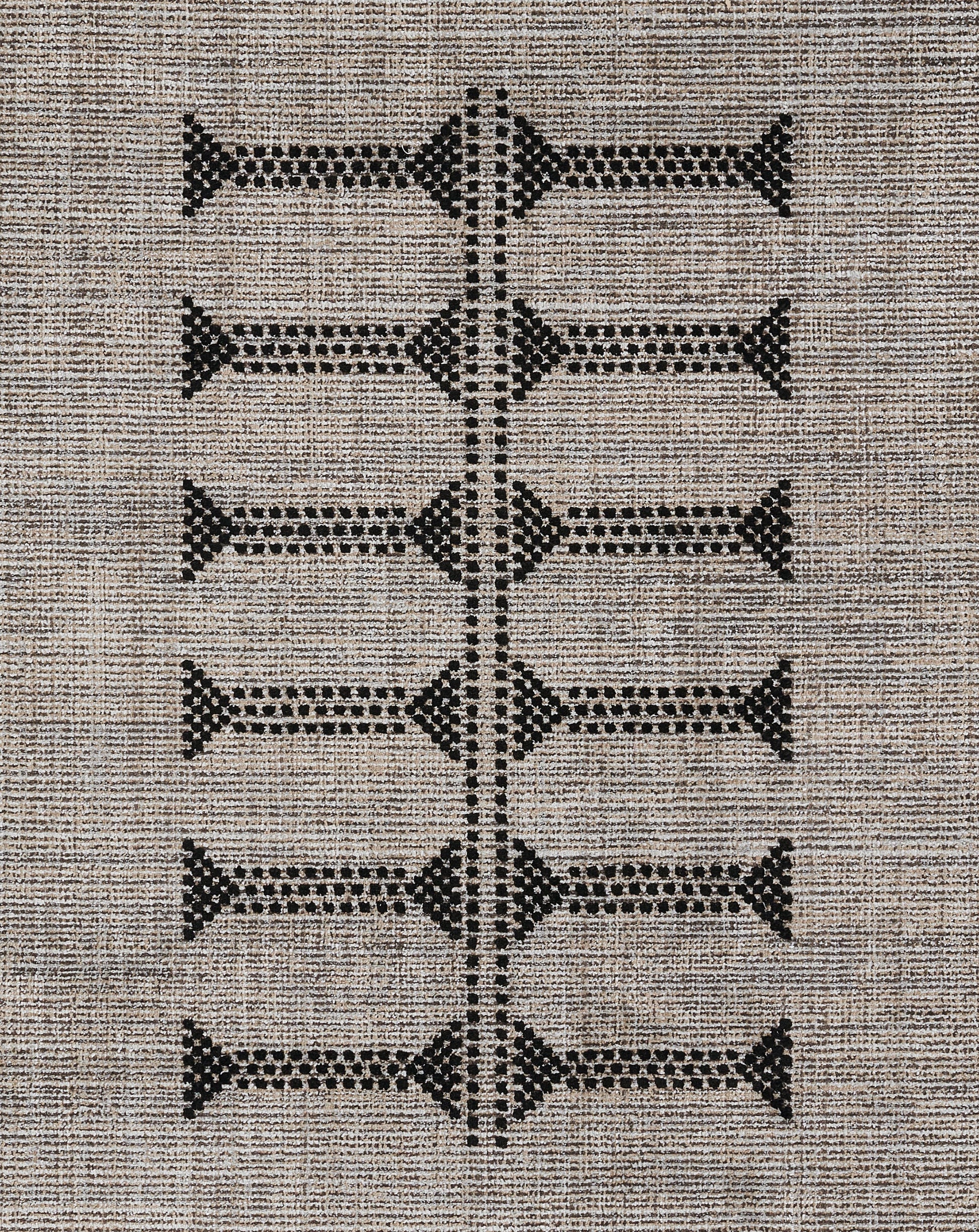 Beige woven area rug with black geometric diamonds arranged in a vertical ladder motif.