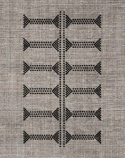 Beige woven area rug with black geometric diamonds arranged in a vertical ladder motif.