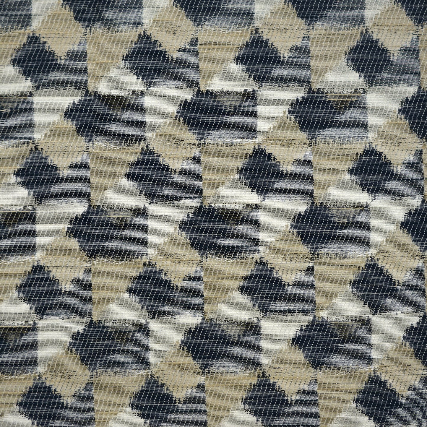 Geometric woven fabric with repeating diamond triangles in blue, creme, beige, offwhite and taupe.