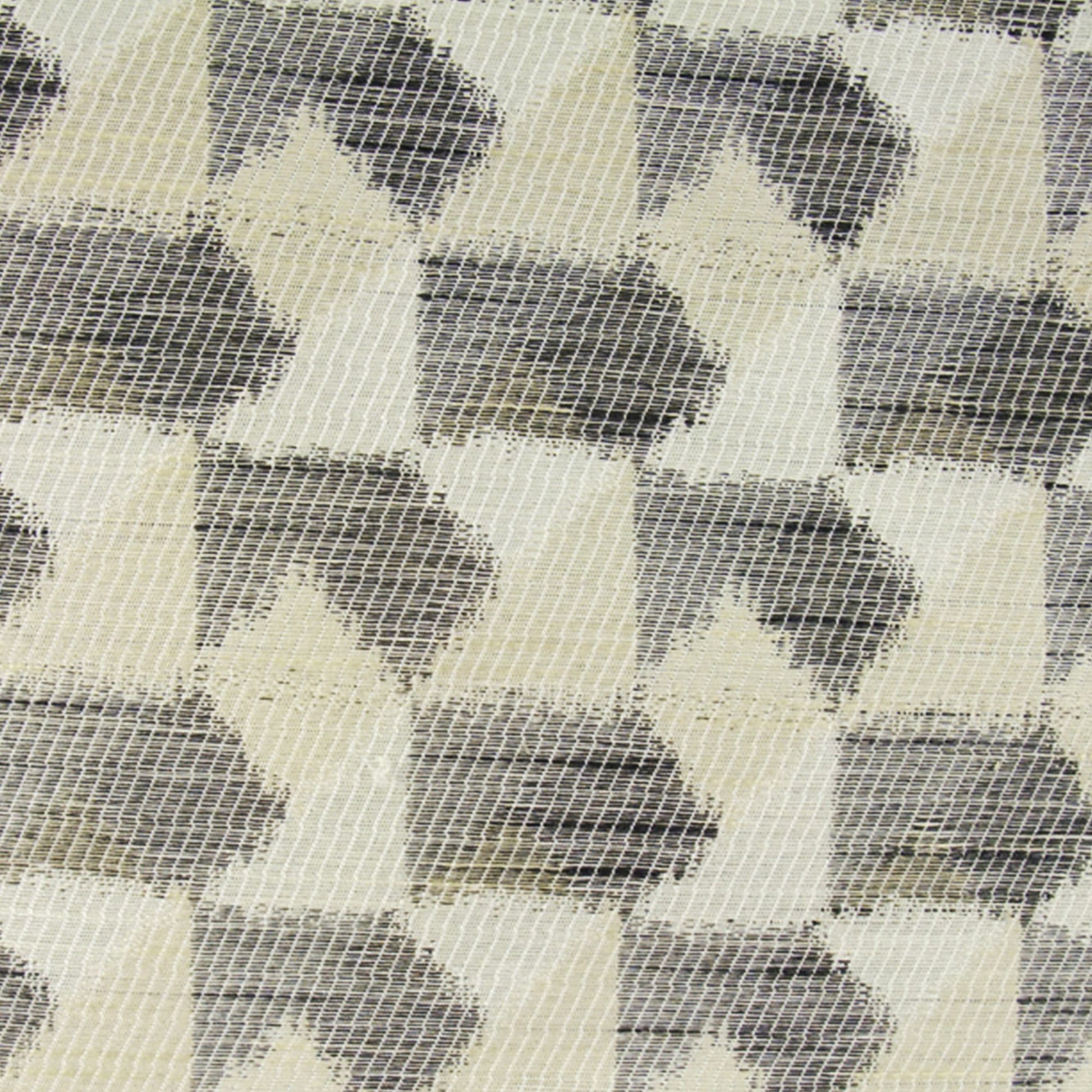 Geometric chevron diamond pattern in cream and gray, woven fabric texture for upholstery or throws.