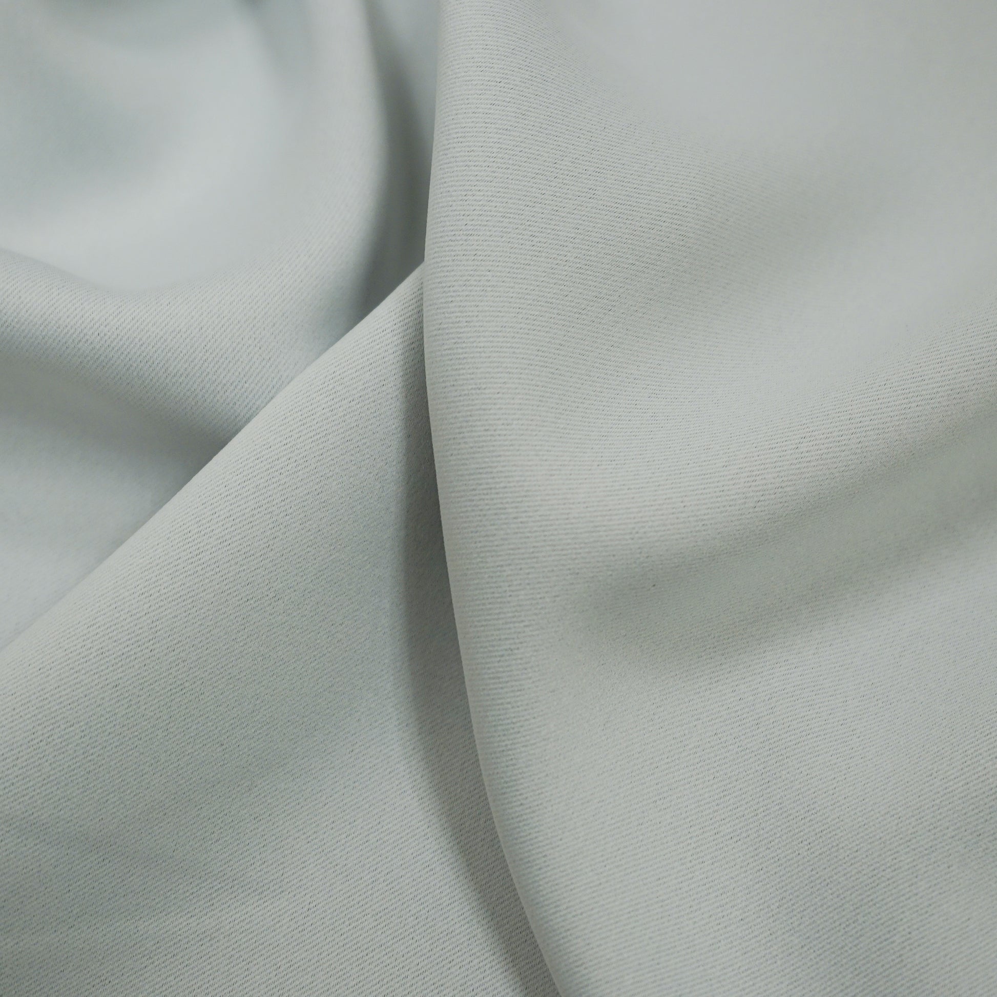 Soft offwhite fabric with a smooth texture and subtle folds; dimout lining fabric.