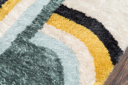 Close-up of a multicolor retro shag rug with teal, light blue, cream, mustard and black curved stripes on wood floor.
