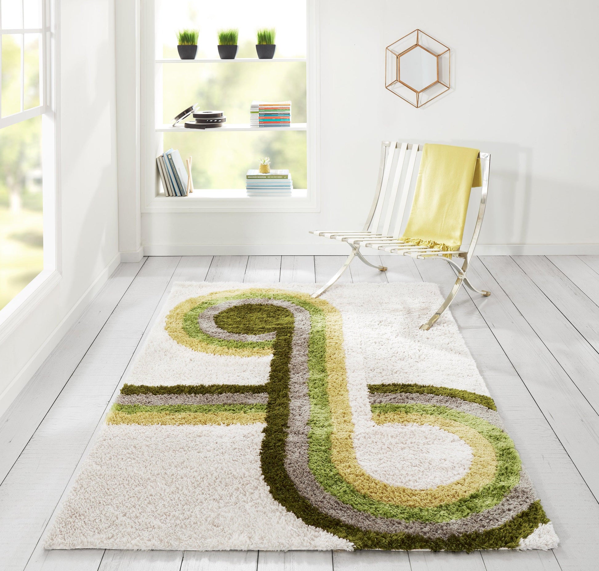 Shaggy white rug with lime-green and olive swirl in minimalist room featuring a chrome lounge chair and yellow throw.