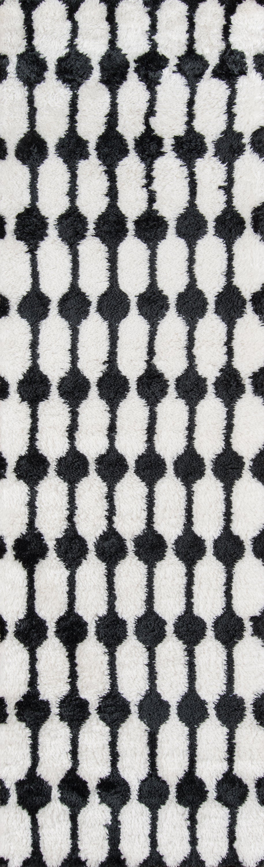 Retro black dot pattern on white rug; vertical repeating columns.