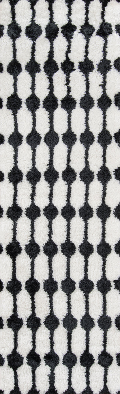 Retro black-and-white fabric pattern featuring vertical rows of oval bead shapes connected by slim lines.