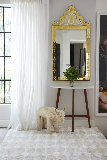 Retro rug on a light floor in a bright living room.