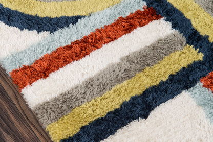 Shaggy retro-striped runner rug with textured pile in yellow, navy, teal, orange, white, gray and beige on wood floor