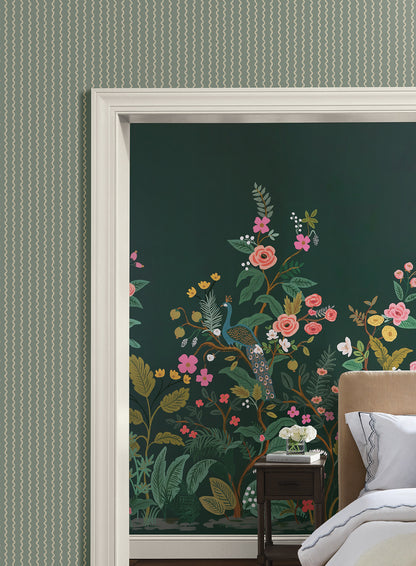 Bedroom with moss-green striped wallpaper on the walls.