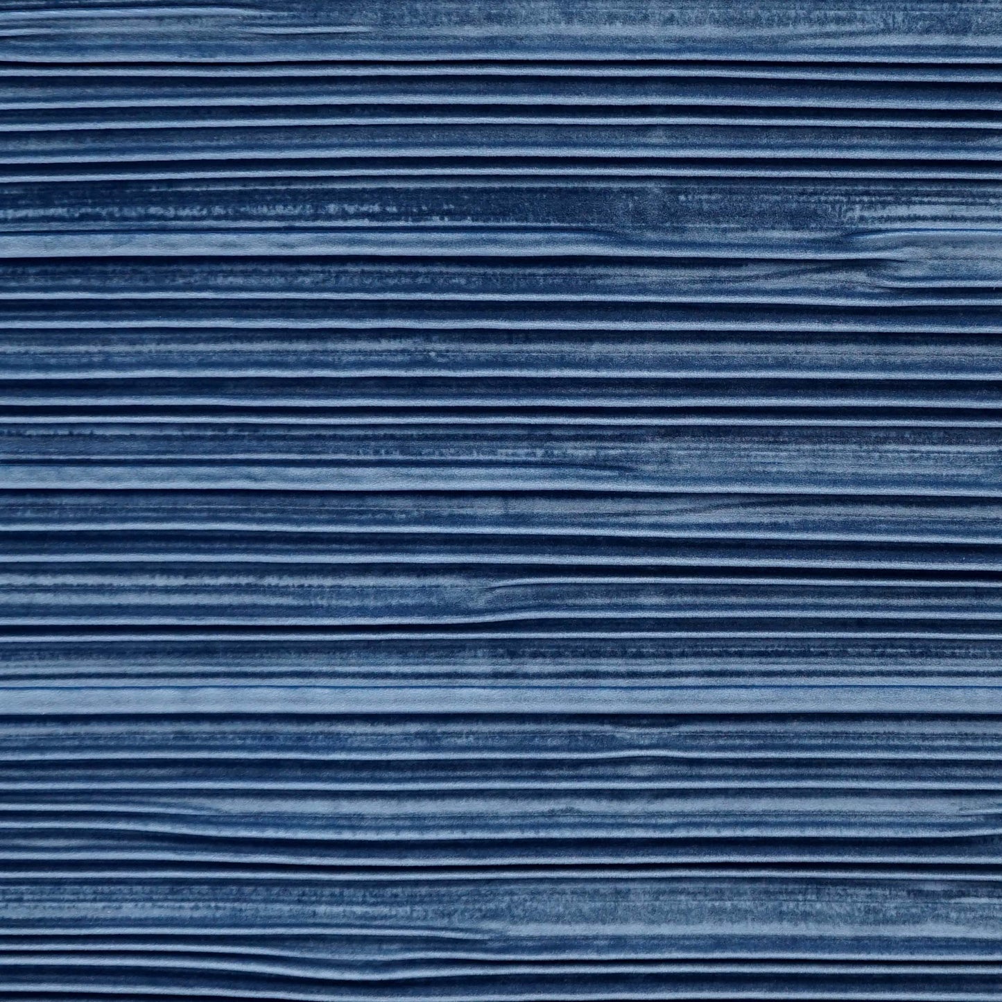 Blue velvet fabric with pleated texture and soft folds.
