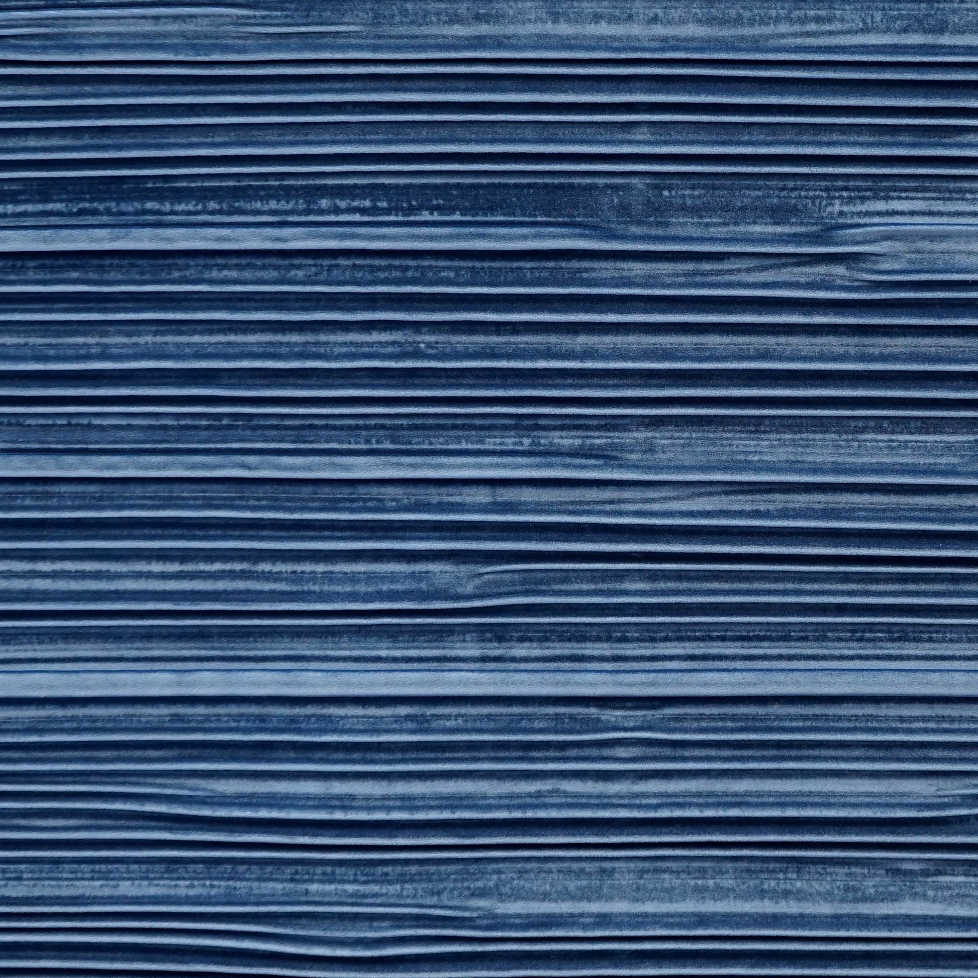 Blue velvet fabric with pleated texture and soft folds.