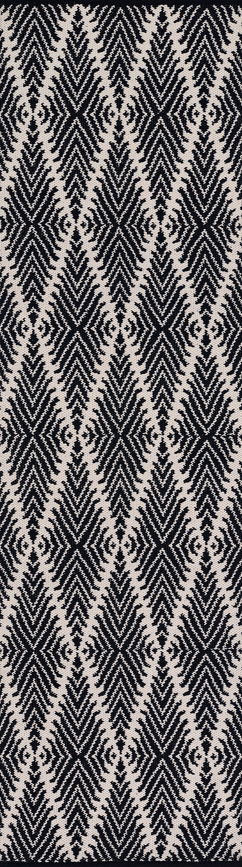 Black woven fabric with a bold off-white chevron/diamond zigzag pattern and feather-like texture.