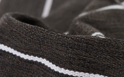 Brown knit fabric with a white stripe, close-up of stitching on a cozy sweater or scarf.