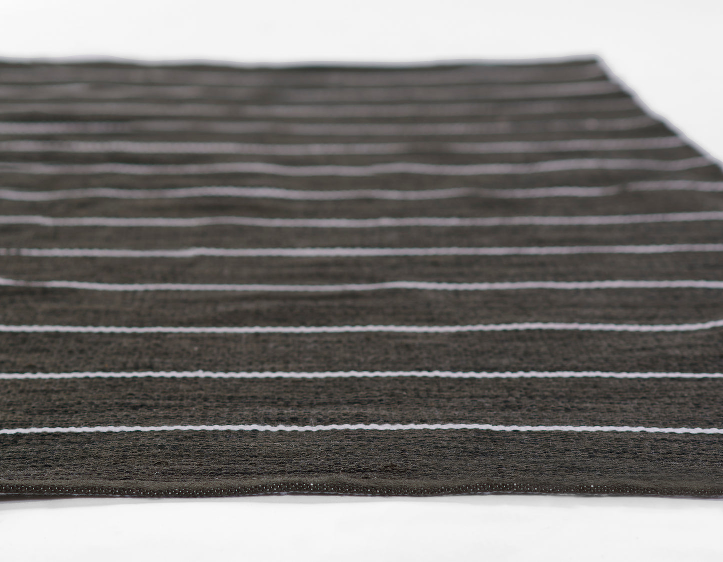 Dark brown flat-weave rug with thin light gray stripes; rectangular, modern minimalist stripe design.