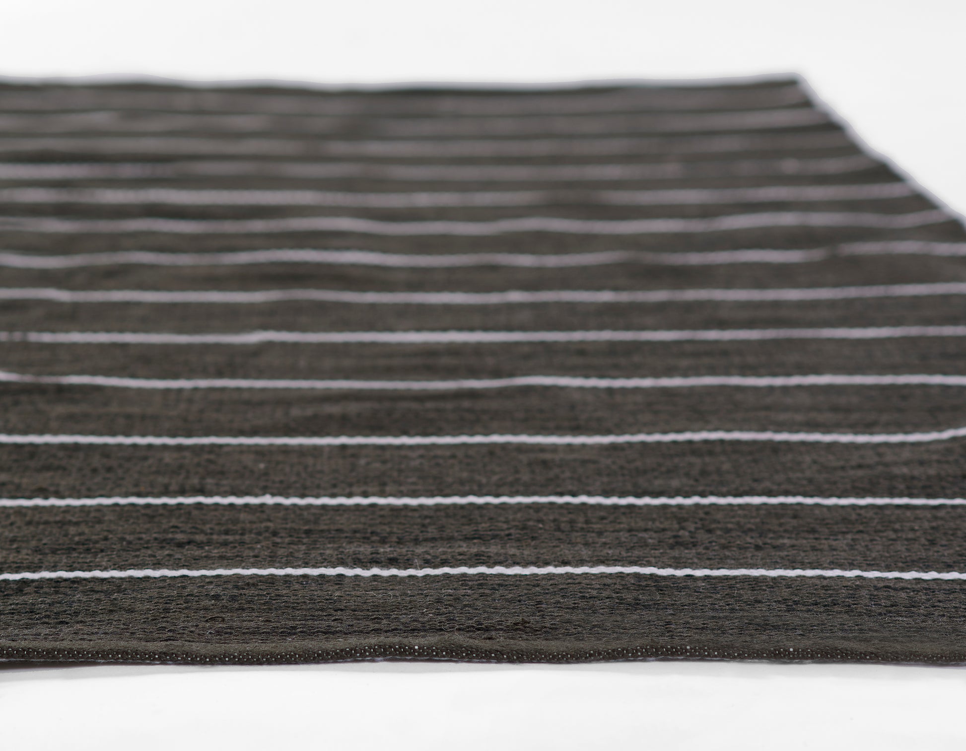 Dark brown flat-weave rug with thin light gray stripes; rectangular, modern minimalist stripe design.