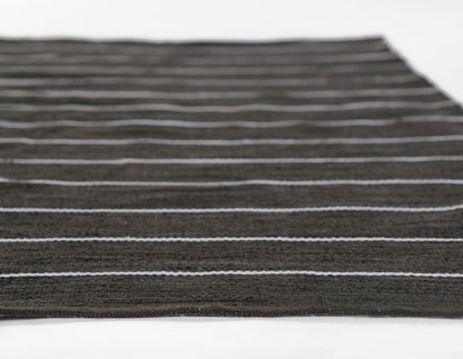 Dark brown striped rug with thin white lines, flatwoven textile, rectangular area rug.