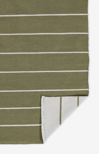 Olive green rug with white horizontal stripes, folded to show a pale underside with thin green lines.