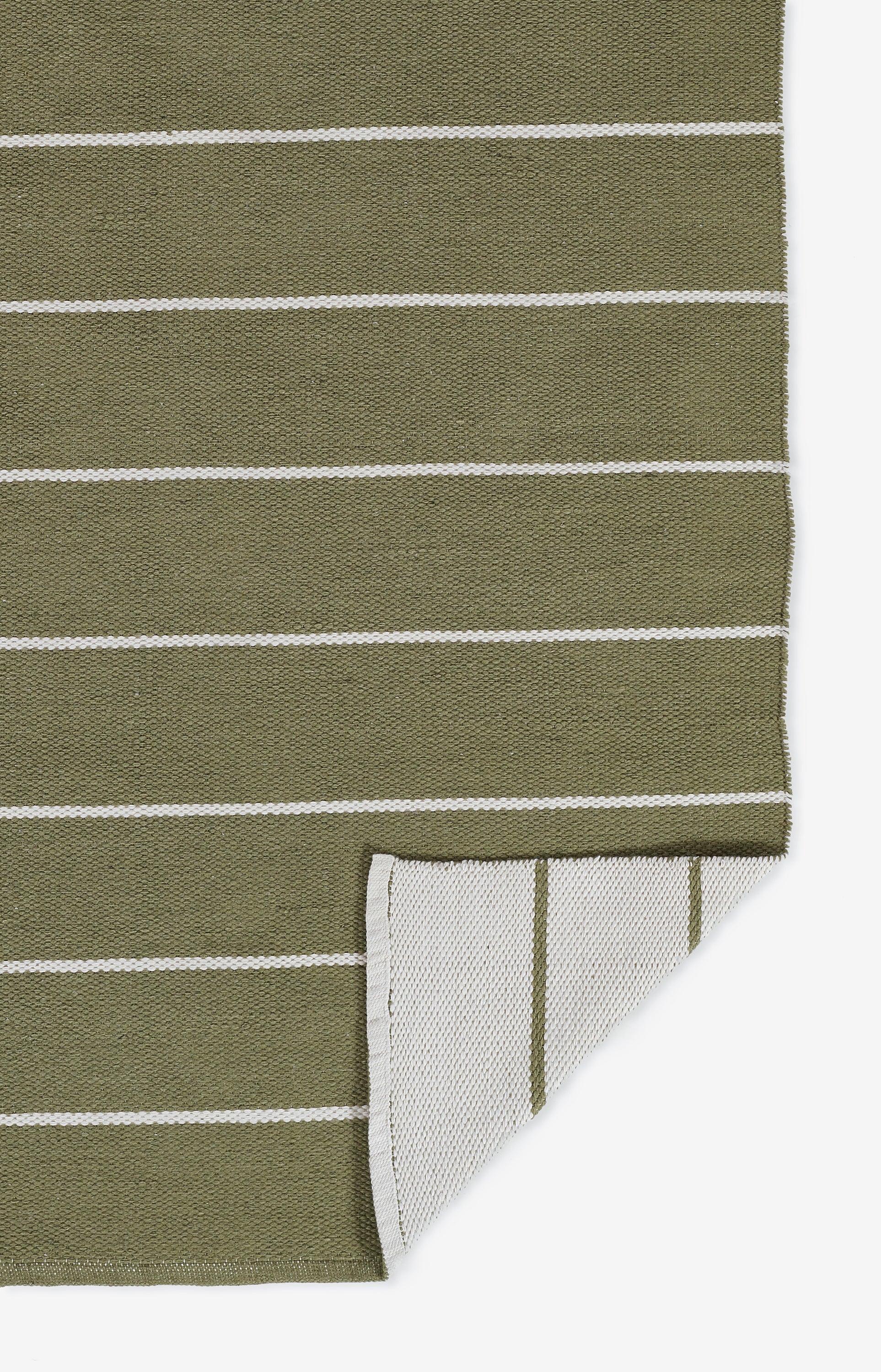 Olive green woven fabric with white horizontal stripes, folded edge showing reverse backing; versatile home decor textile.
