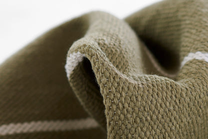 Close-up of olive-green ribbed knit fabric with a white stripe, soft wool-like texture.