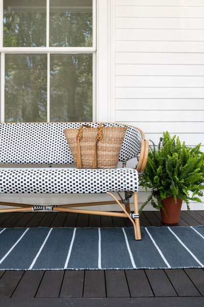 Outdoor 2' x 8' striped rug runner on a wooden porch.