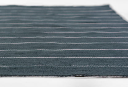 Blue-gray striped fabric with slim white horizontal stripes, woven texture, flat on white background with visible edge hem.